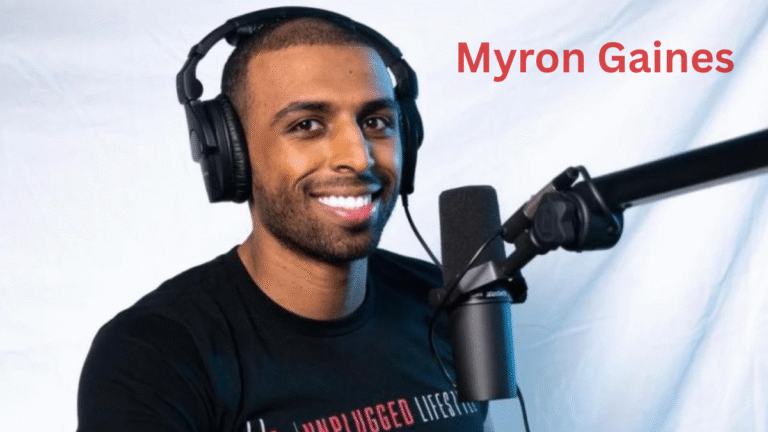 Myron Gaines speaking into a microphone during a Fresh and Fit podcast episode, wearing headphones and sitting in the studio