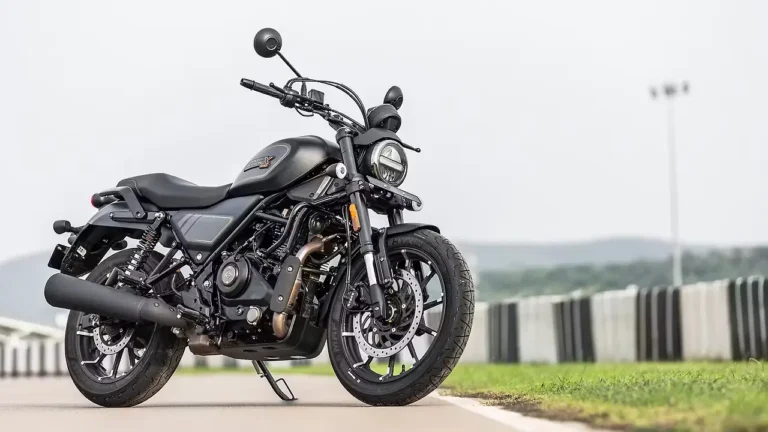 Harley-Davidson X440 side view showcasing retro-modern design, LED headlamp, and muscular fuel tank in scenic outdoor background.